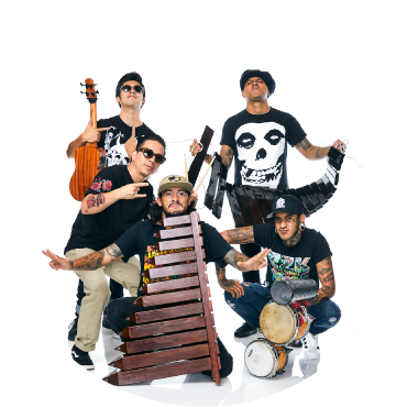 Son Rompe Pera poses together against a white backdrop with a guitar, two marimbas, and drums