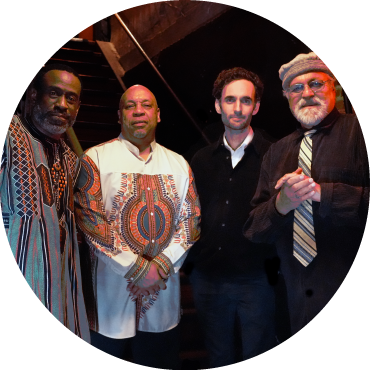 Members of the quartet pose together by a stairwell. 